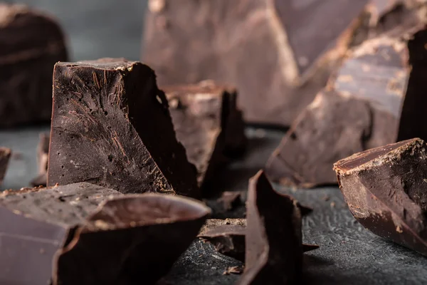 Chocolate. Black chocolate. A few cubes of black chocolate. Chocolate chunks. Chocolate bar pieces