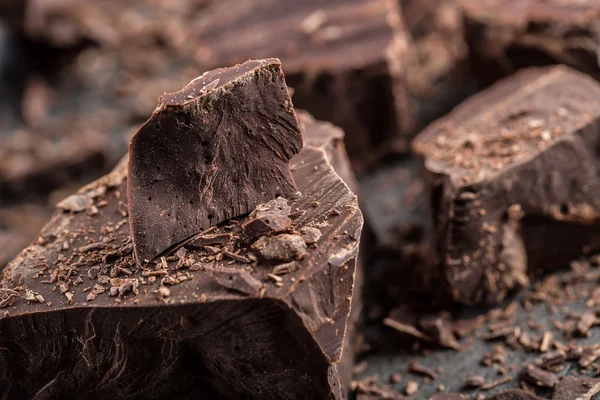 Chocolate. Black chocolate. A few cubes of black chocolate. Chocolate chunks. Chocolate bar pieces