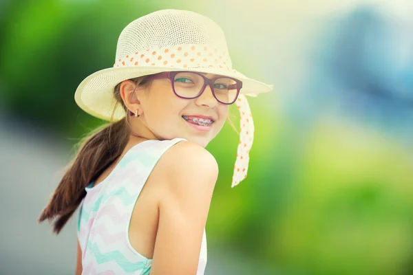 Girl.Happy girl teen pre teen. Girl with glasses. Girl with teeth braces. Young cute caucasian blond girl in summer outfit — Stock Photo, Image