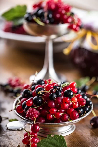 Red and black currants. red currant jam with fresh berry