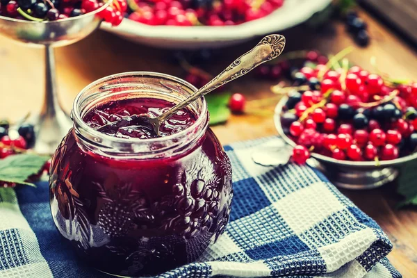 Red and black currants. red currant jam with fresh berry