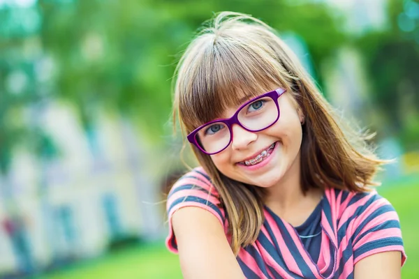 Girl. Teen. Pre teen. Girl with glasses. Girl with teeth braces. Young cute caucasian blond girl wearing teeth braces and glasses — Stock Photo, Image