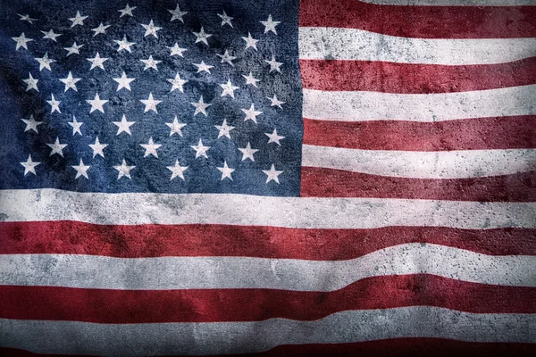 USA flag. American flagon concrete background. American flag blowing wind. Close-up. Studio shot — Stock Photo, Image