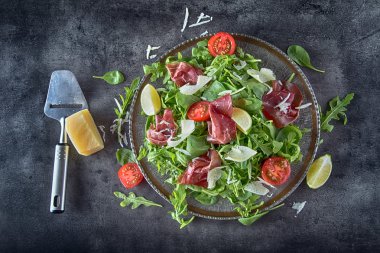 Kurutulmuş sığır eti bresaola. Kireç ve parmesan peynir salata bresaola roka bebek ıspanak domates