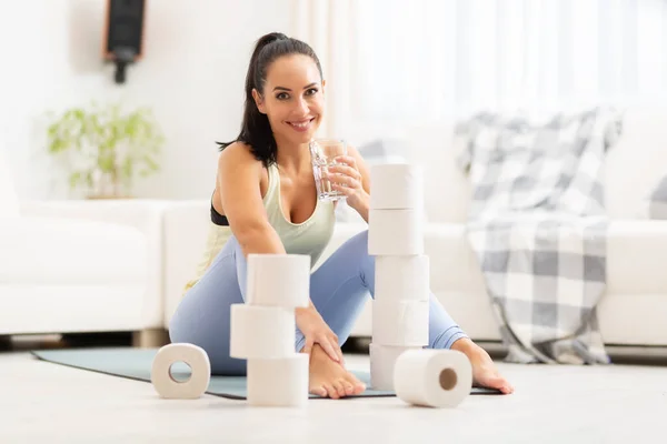 Smiling Woman Drinks Glass Water Aftera Home Workout Surrounded Toilet — Stock Photo, Image