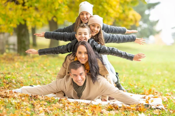 Arms Wide Open Mom Dad Three Kids Piled Outdoors Autumn — Stock Photo, Image