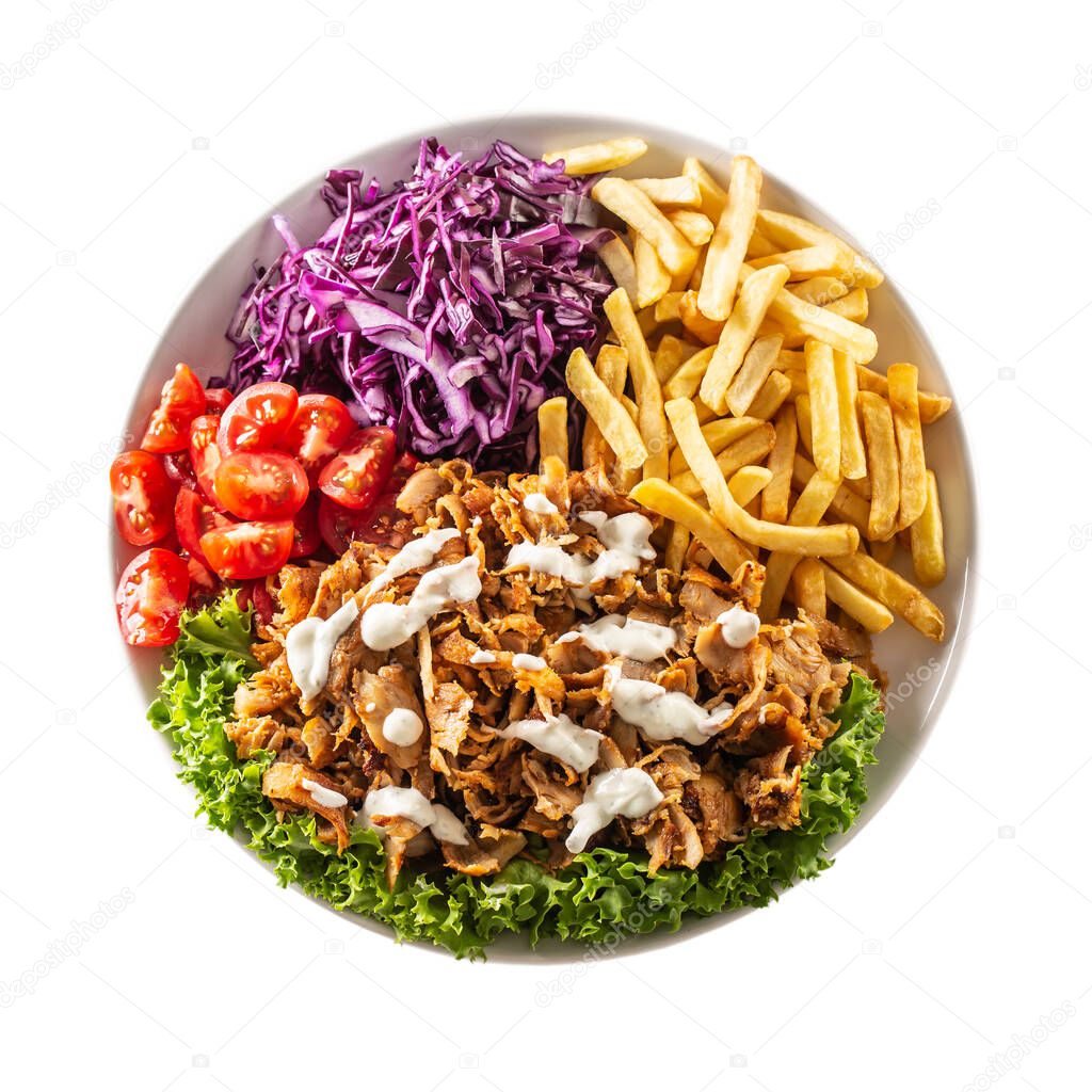 Top view isolated traditional Turkish chicken kebab prepared with lovely fries, fresh vegetables and yummy dressing.