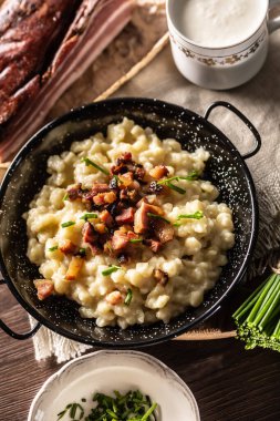 Domuz pastırması ve soğanla kaplı tipik Slovakya yemeği haluski peyniri..
