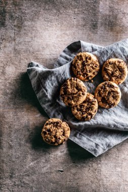 Çikolata parçalı kurabiyeler gevşek bir şekilde keten peçeteye serilmişti - yukarıdan bakıldığında