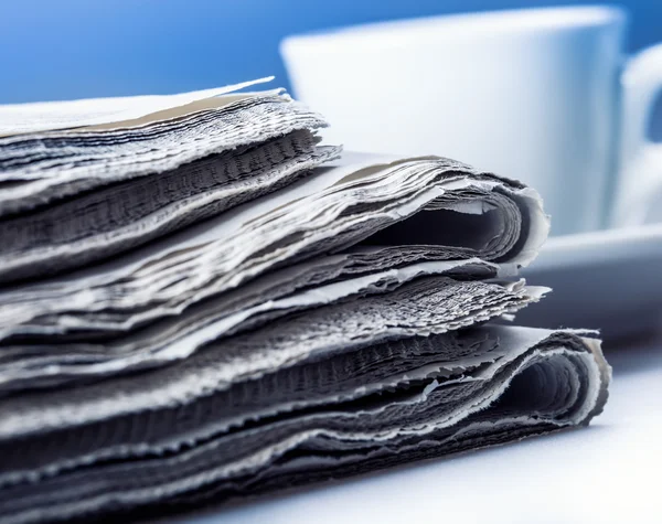 Several pieces of newspaper on a table — Stock Photo, Image