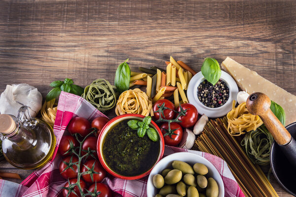 Italian and Mediterranean food ingredients on old wooden background.