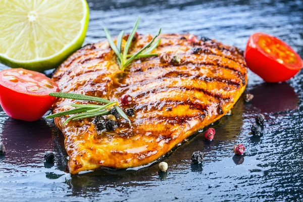 Steak chicken breast olive oil cherry tomatoes pepper and rosemary herbs. — Stock Photo, Image