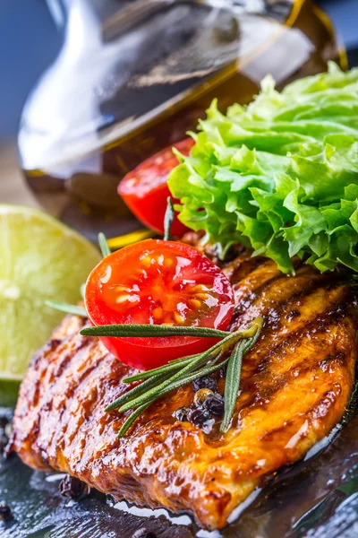 Steak chicken breast olive oil cherry tomatoes pepper and rosemary herbs. — Stock Photo, Image