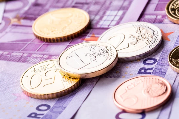 Several 500 euro banknotes and coins are adjacent. Symbolic photo for wealth — Stock Photo, Image