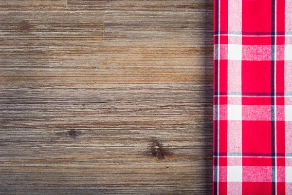 Top view of checkered napkin on wooden table. — Stock Photo, Image