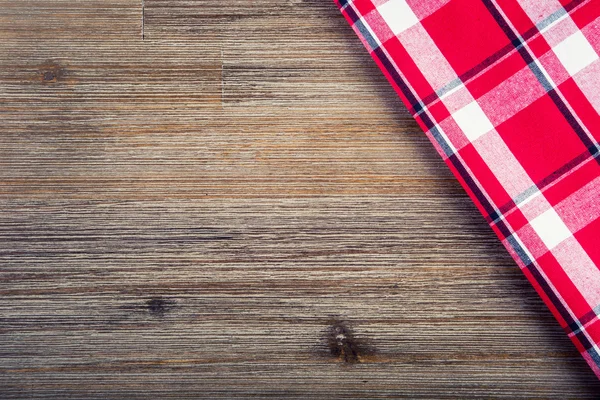Top view of checkered napkin on wooden table. — Stock Photo, Image
