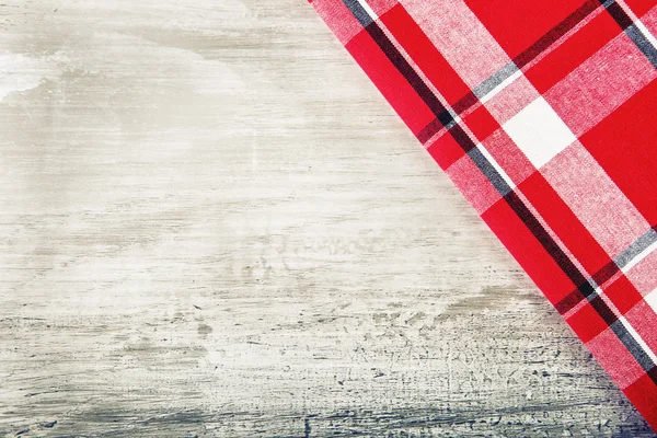 Top view of checkered napkin on wooden table. — Stock Photo, Image