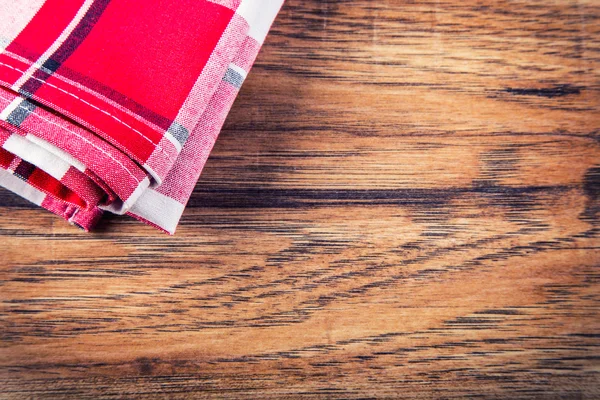 Vue du dessus de la serviette à carreaux sur une table en bois . — Photo