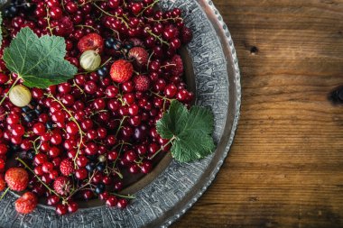 Red currant sponge cake. Plate with Assorted summer berries, raspberries, strawberries, cherries, currants, gooseberries.