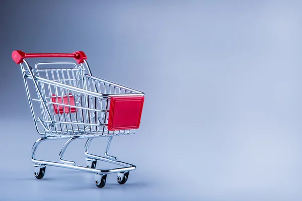 Shopping trolley. Shopping cart. Shopping trolley on muti collored background. Zdjęcia Stockowe bez tantiem