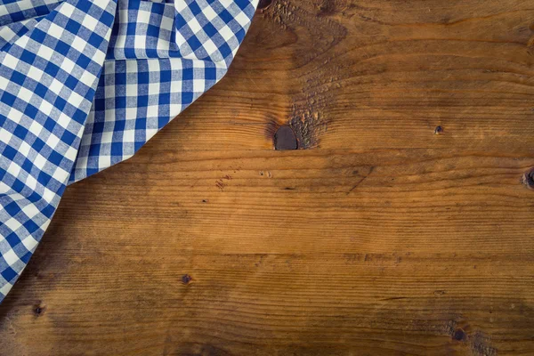 Top view of checkered napkin on old wooden table — Stock Photo, Image