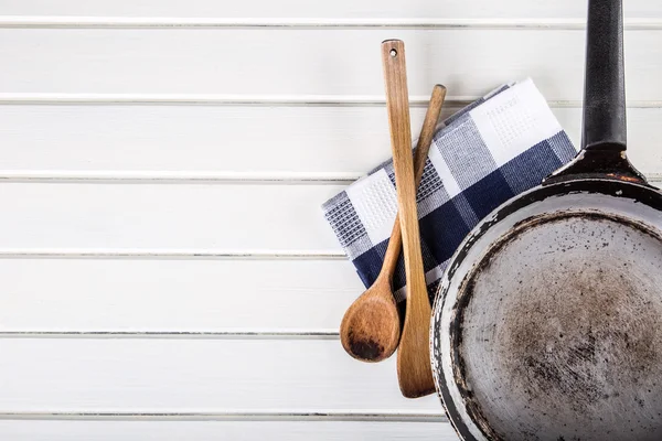 Wooden kitchen utensils on the table. Wooden spoon old pan in a retro style on wooden table. — Stock Fotó