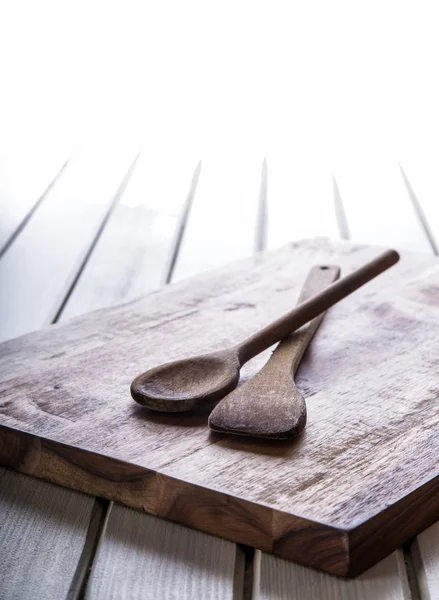Utensilios de cocina de madera en el tablero. Cuchara de madera en el tablero y la mesa de madera . — Foto de Stock