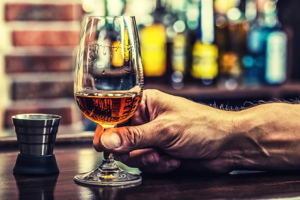 Alcoholism. Hand alcoholic and drink the distillate brandy or cognac. — Stock Photo, Image