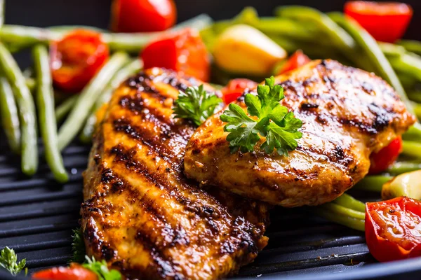 Grilled chicken breast in different variations with cherry tomat