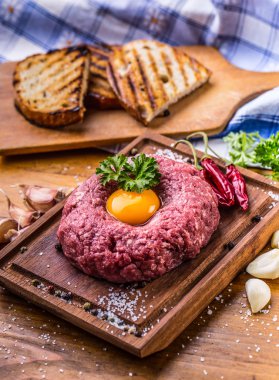 Raw beef .Tasty Steak tartare. Classic steak tartare on wooden b