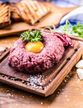 Raw beef .Tasty Steak tartare. Classic steak tartare on wooden b