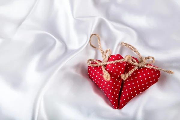 Valentines day. Hand made valentine heart. Wedding day. Red valentines hearts on white satin. Text: I love you — Zdjęcie stockowe