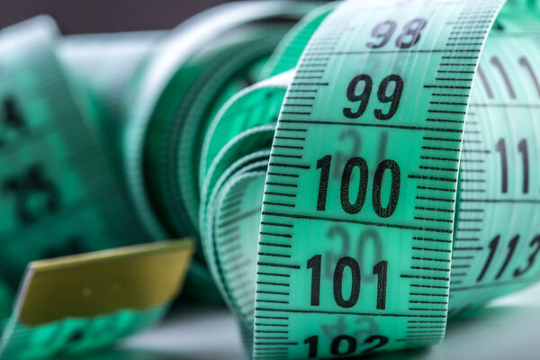 urved measuring tape. Measuring tape of the tailor. Closeup view of Green measuring tape