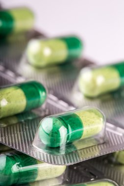 Pills. Tablets. Capsule. Heap of pills. Medical background. Close-up of pile of yellow green tablets - capsule. Pills and tablets