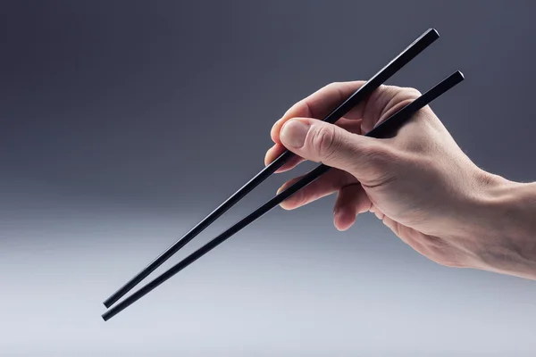 Asian tradition. Asian eating with two Handle Chopsticks. — стокове фото