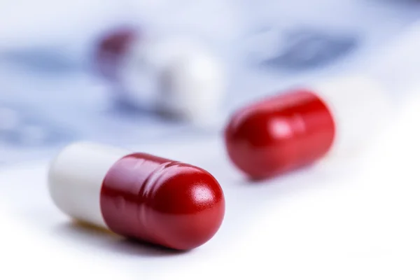 Pills. Tablets. Capsule. Heap of pills. Medical background. Close-up of pile of red white tablets - capsule. Pills and tablets.Blue background — Stockfoto