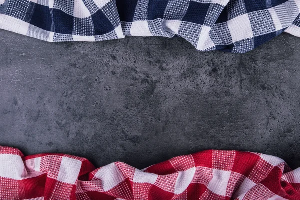 Top view of checkered kitchen tablecloth on granite -  concrete - stone background. Free space for your text or products — Stock Photo, Image