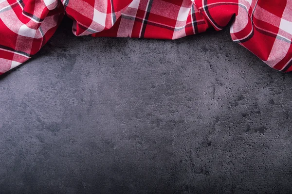 Top view of checkered kitchen tablecloth on granite -  concrete - stone background. Free space for your text or products — Stock Photo, Image