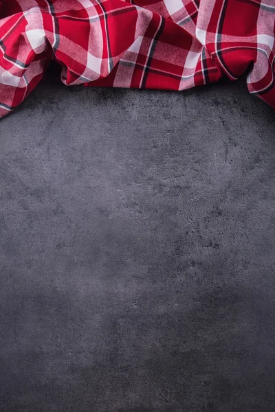 Top view of checkered kitchen tablecloth on granite -  concrete - stone background. Free space for your text or products — Stock Fotó