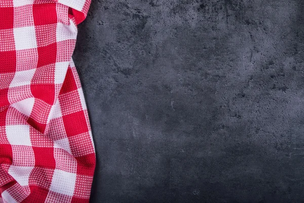 Top view of checkered kitchen tablecloth on granite -  concrete - stone background. Free space for your text or products — Stockfoto