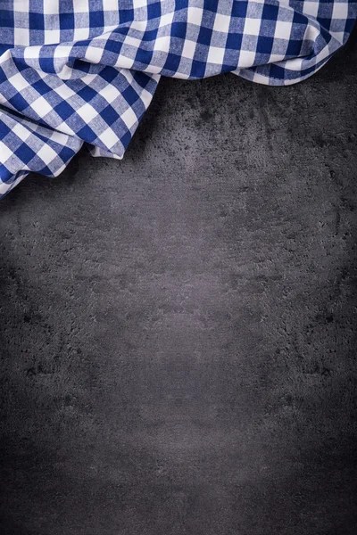 Top view of checkered kitchen tablecloth on granite -  concrete - stone background. Free space for your text or products — Stok fotoğraf