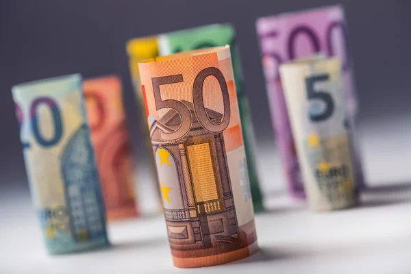 Several hundred euro banknotes stacked by value. Euro money concept. Rolls Euro  banknotes. Euro currency. Announced cancellation of five hundred euro banknotes. Banknotes stacked on each other in different positions. Toned photo — Stock Photo, Image