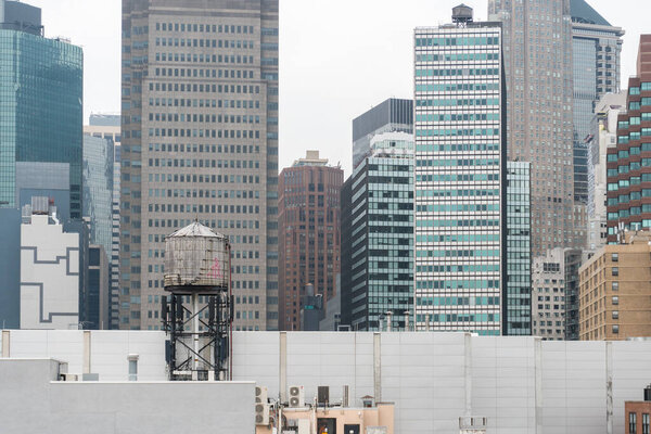 New York City, USA - August 6, 2019:Daily life in New York city during a cloudy day.Here a view of skyscrapers and old water tank