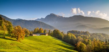 Beautiful autumn landscape with traditional farm house in the Alps clipart