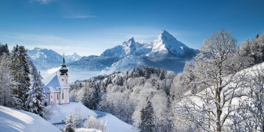 Scenic winter landscape in the Alps with small pilgrimage church clipart