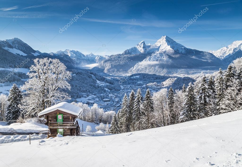 Idyllic winter landscape the Alps with traditional mountain chalet