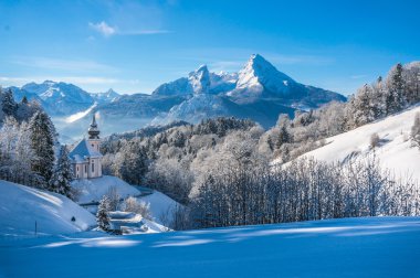 Panoramic view of beautiful winter landscape in the Bavarian Alps with pilgrimage church of Maria Gern and famous Watzmann massif in the background, Nationalpark Berchtesgadener Land, Bavaria, Germany clipart