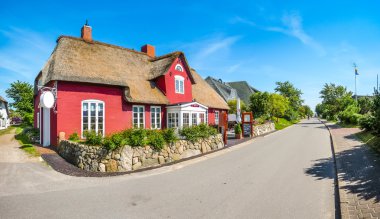 Beautiful and traditional thatched house in german north sea village clipart