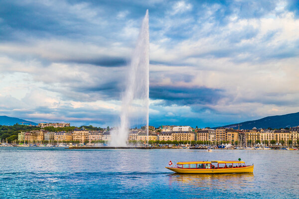 City of Geneva with famous Jet d'Eau fountain at sunset, Switzerland