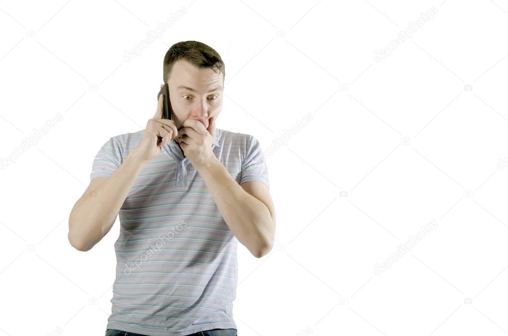frightened man talking on the phone isolated on a white 